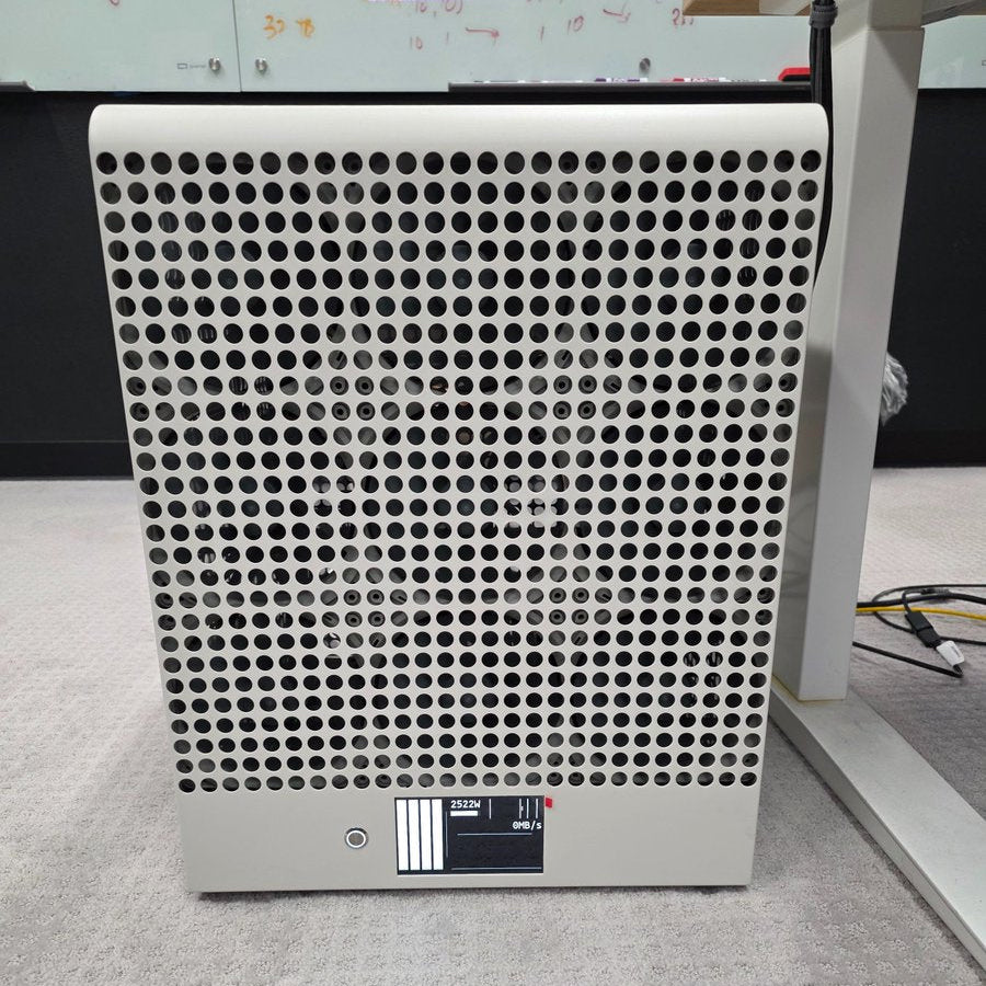 Rectangular air purifier with perforated design on a gray floor